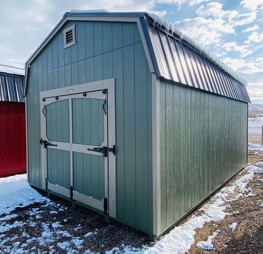 Green 10x16 farmhouse style storage shed.