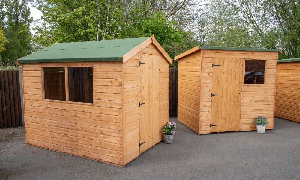 Treated wood storage shed for backyard or garden use.