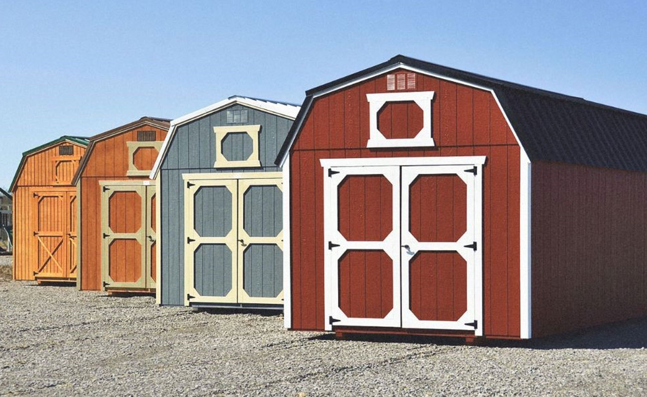 Wooden storage sheds in multiple colors.