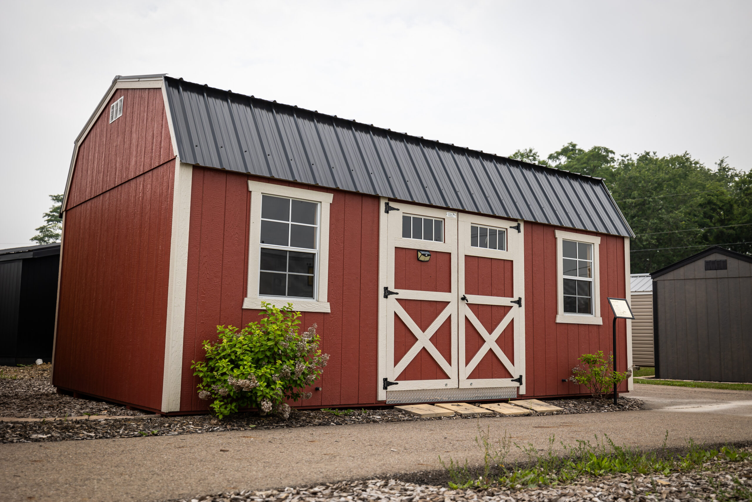Red lofted barn with black metal roof, monthly payments available with rent to own