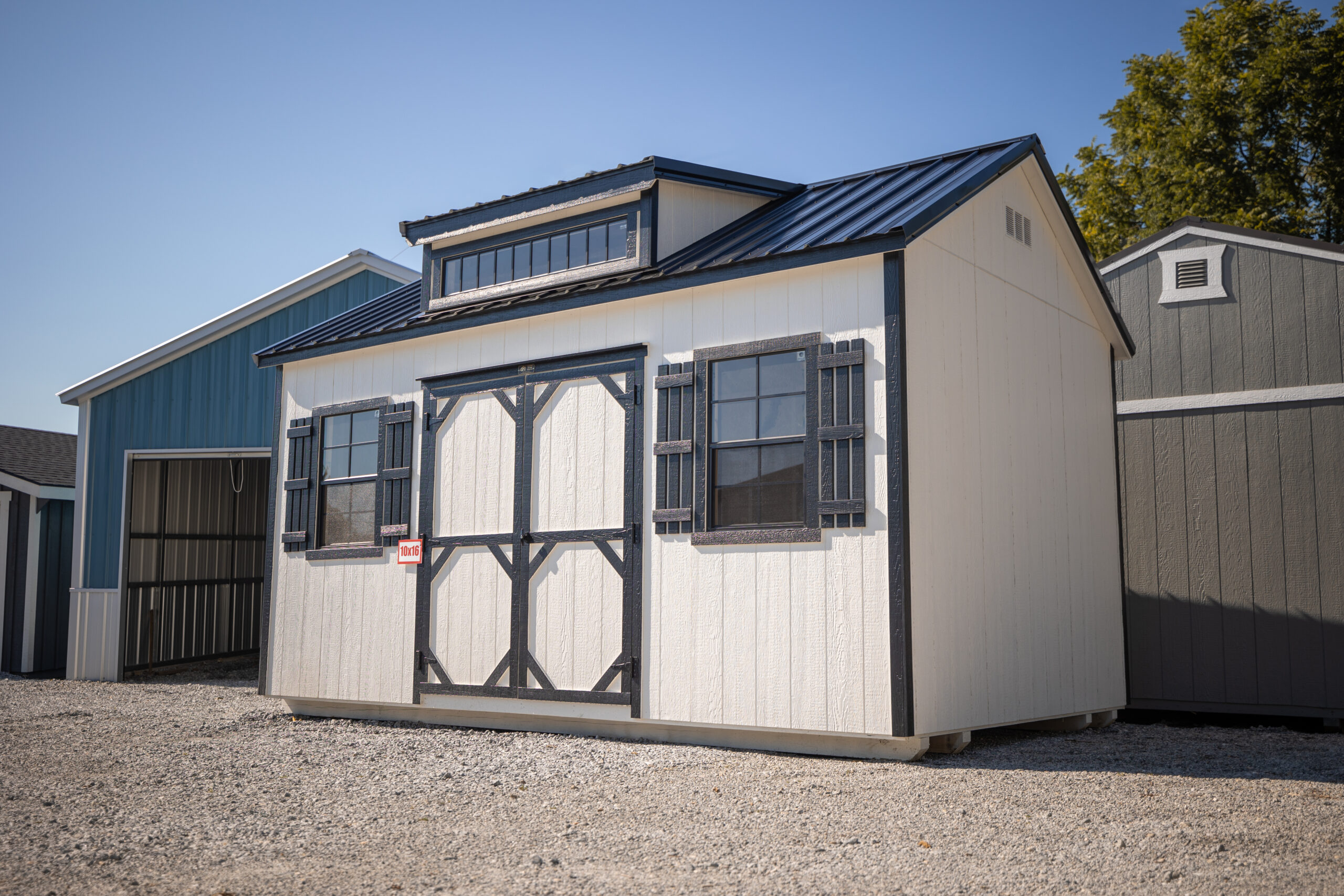 White garden shed with dormer and shutters, monthly payments available with rent to own